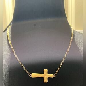 Gold tone sideways cross necklace